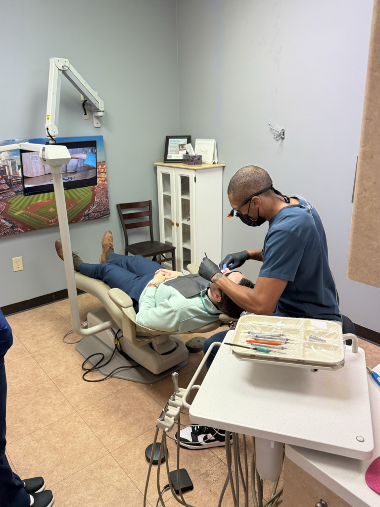 Dentist providing professional dental care to a patient at Wilson Family Dental in St. Charles, Missouri, highlighting modern treatment and patient-focused dentistry