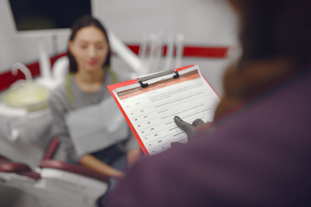 Patient completing dental appointment forms at St. Charles MO dentist office