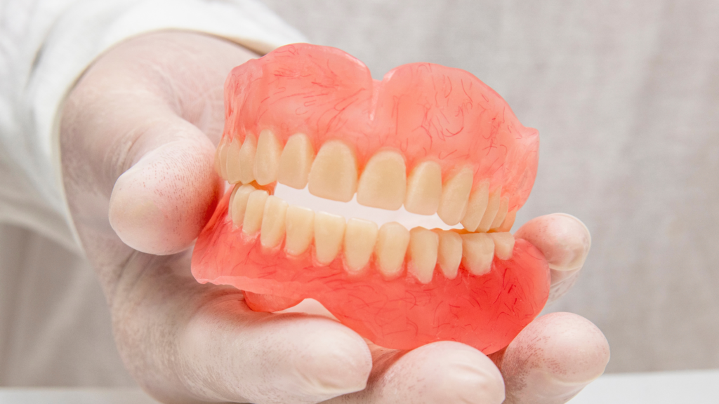 Dentist holding model of dentures