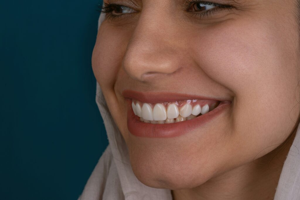 Close-up of a smiling woman showing bright teeth